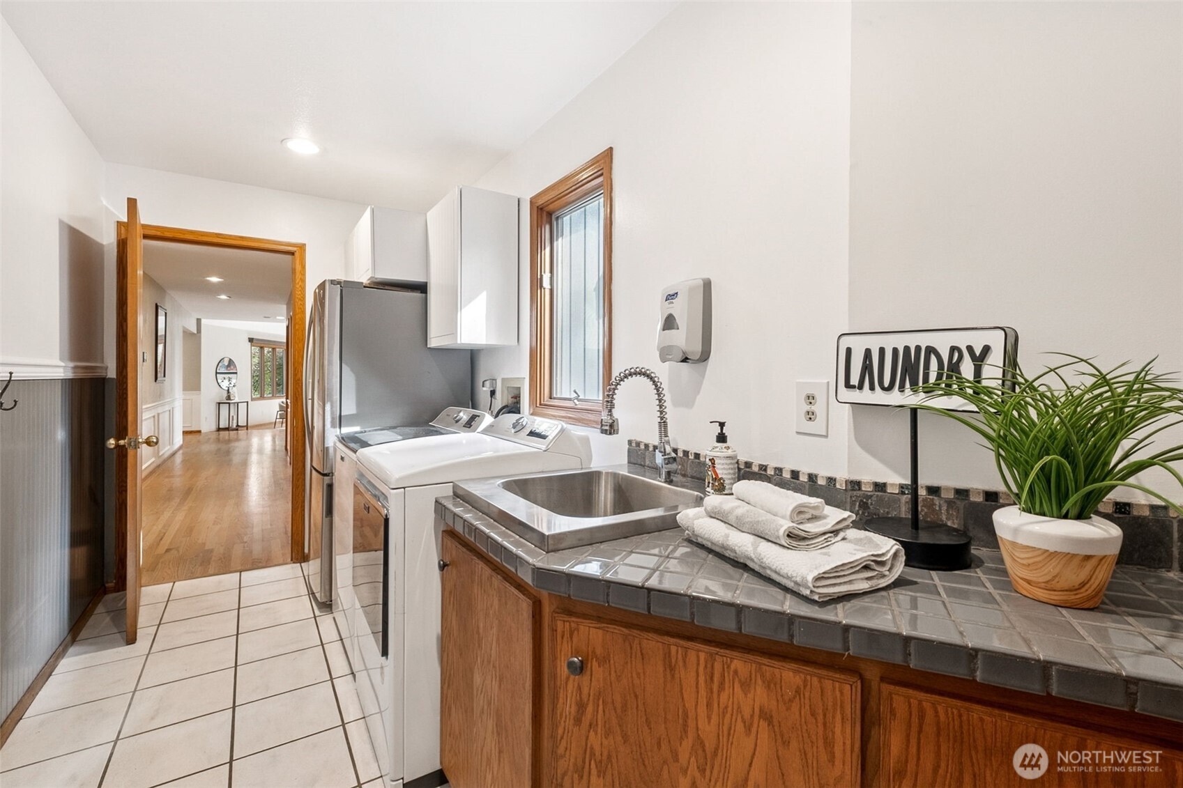 21720 Southeast 246th Street Maple Valley, WA 98038 - Photo 20 of 38 a kitchen with sink and refrigerator