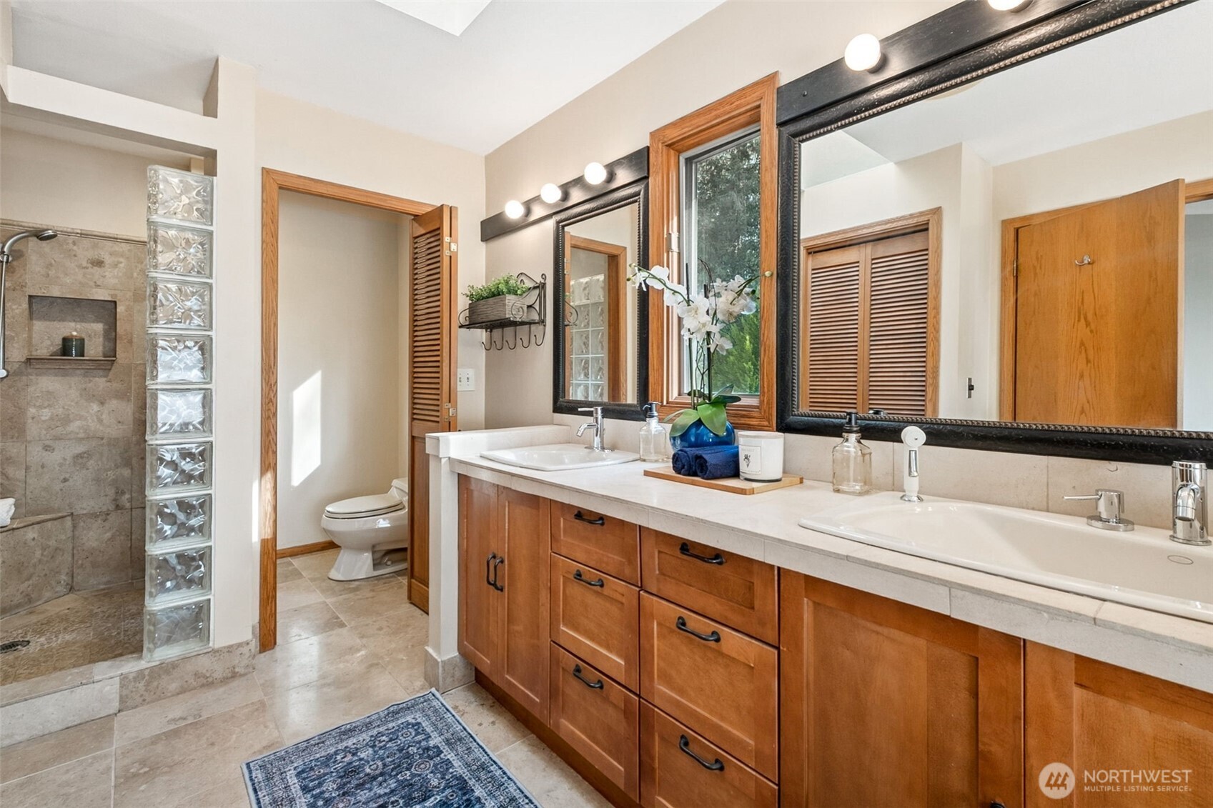 21720 Southeast 246th Street Maple Valley, WA 98038 - Photo 22 of 38 a spacious bathroom with a double vanity sink a mirror and a shower
