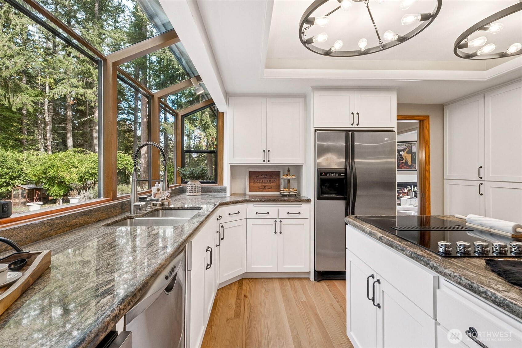21720 Southeast 246th Street Maple Valley, WA 98038 - Photo 8 of 38 a kitchen with a sink appliances cabinets and a large window