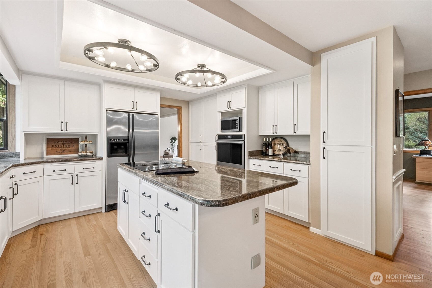 21720 Southeast 246th Street Maple Valley, WA 98038 - Photo 9 of 38 a kitchen with stainless steel appliances granite countertop a sink and cabinets