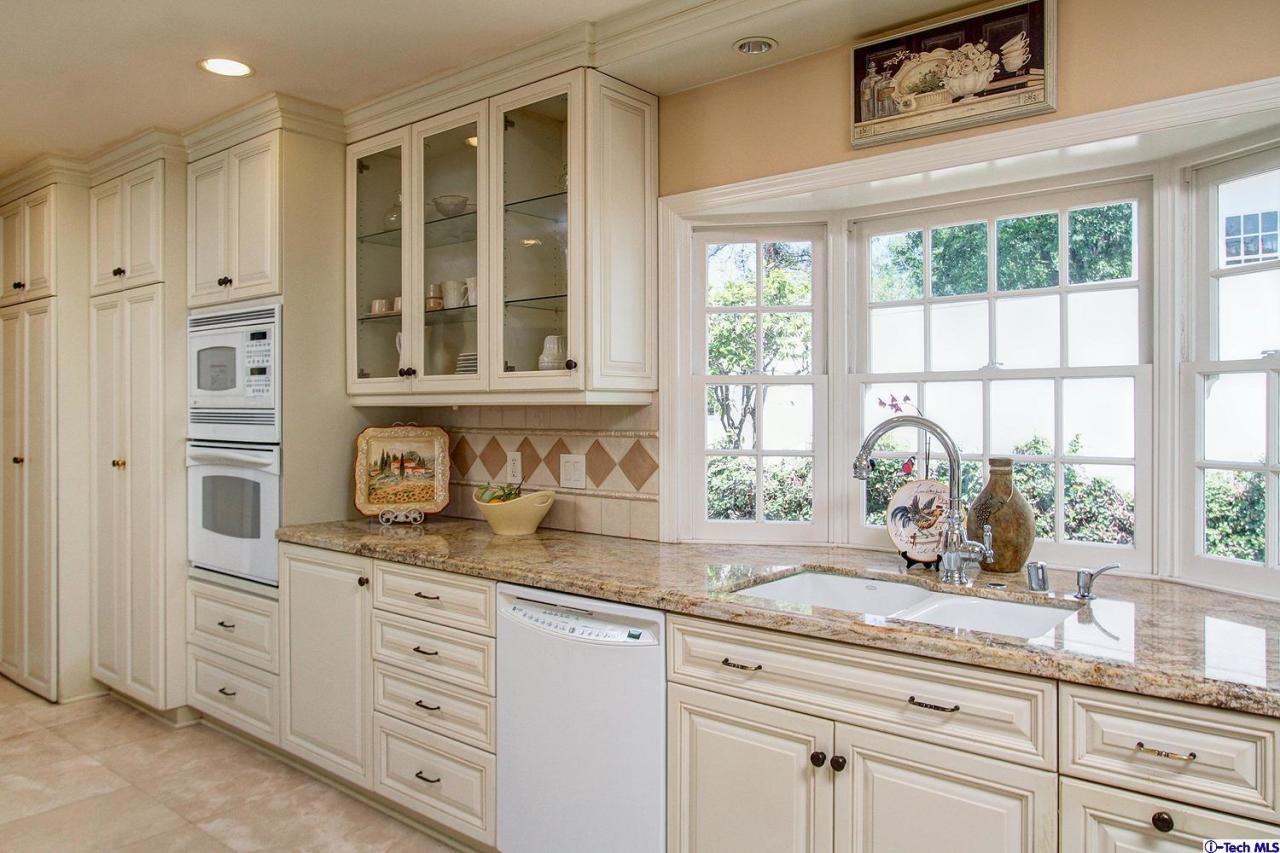931 Roxbury Road San Marino, CA 91108 - Photo 14 of 37 a kitchen with granite countertop a window sink and cabinets