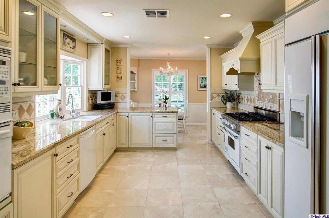 931 Roxbury Road San Marino, CA 91108 - Photo 16 of 37 a large white kitchen with granite countertop a large window and white stainless steel appliances