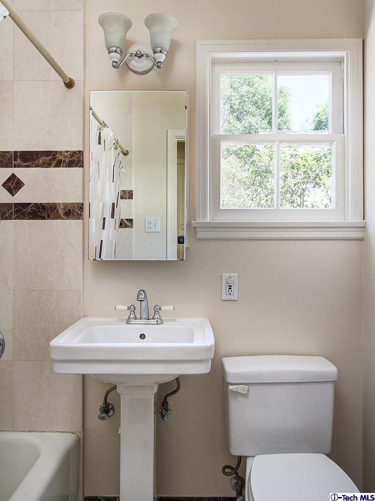 931 Roxbury Road San Marino, CA 91108 - Photo 17 of 37 a bathroom with a sink a mirror and a toilet
