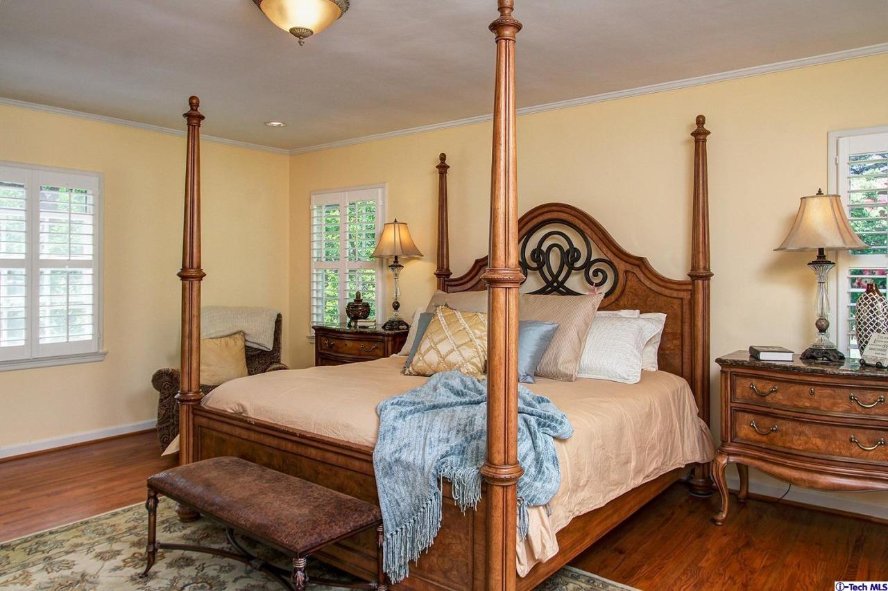931 Roxbury Road San Marino, CA 91108 - Photo 19 of 37 a bedroom with a bed next to a window with outer view