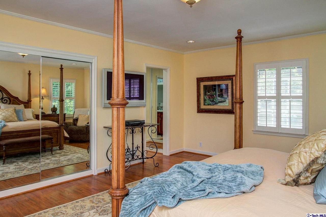 931 Roxbury Road San Marino, CA 91108 - Photo 20 of 37 a bedroom with a bed and wooden floor