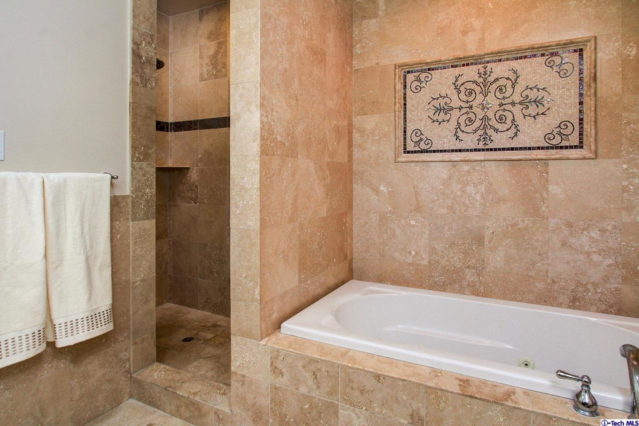 931 Roxbury Road San Marino, CA 91108 - Photo 23 of 37 a bathroom with a bathtub and shower