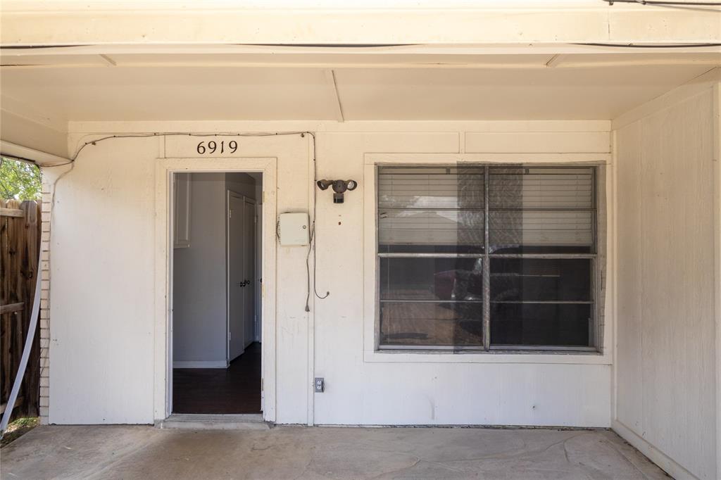 6919 West Cleburne Road Fort Worth, TX 76133 - Photo 11 of 40 Covered entry with concrete flooring