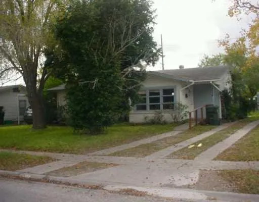 a front view of a house with a yard and a garage