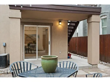 a view of a house with a dining table and chairs
