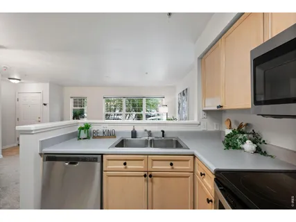 a kitchen with a sink a refrigerator and a stove