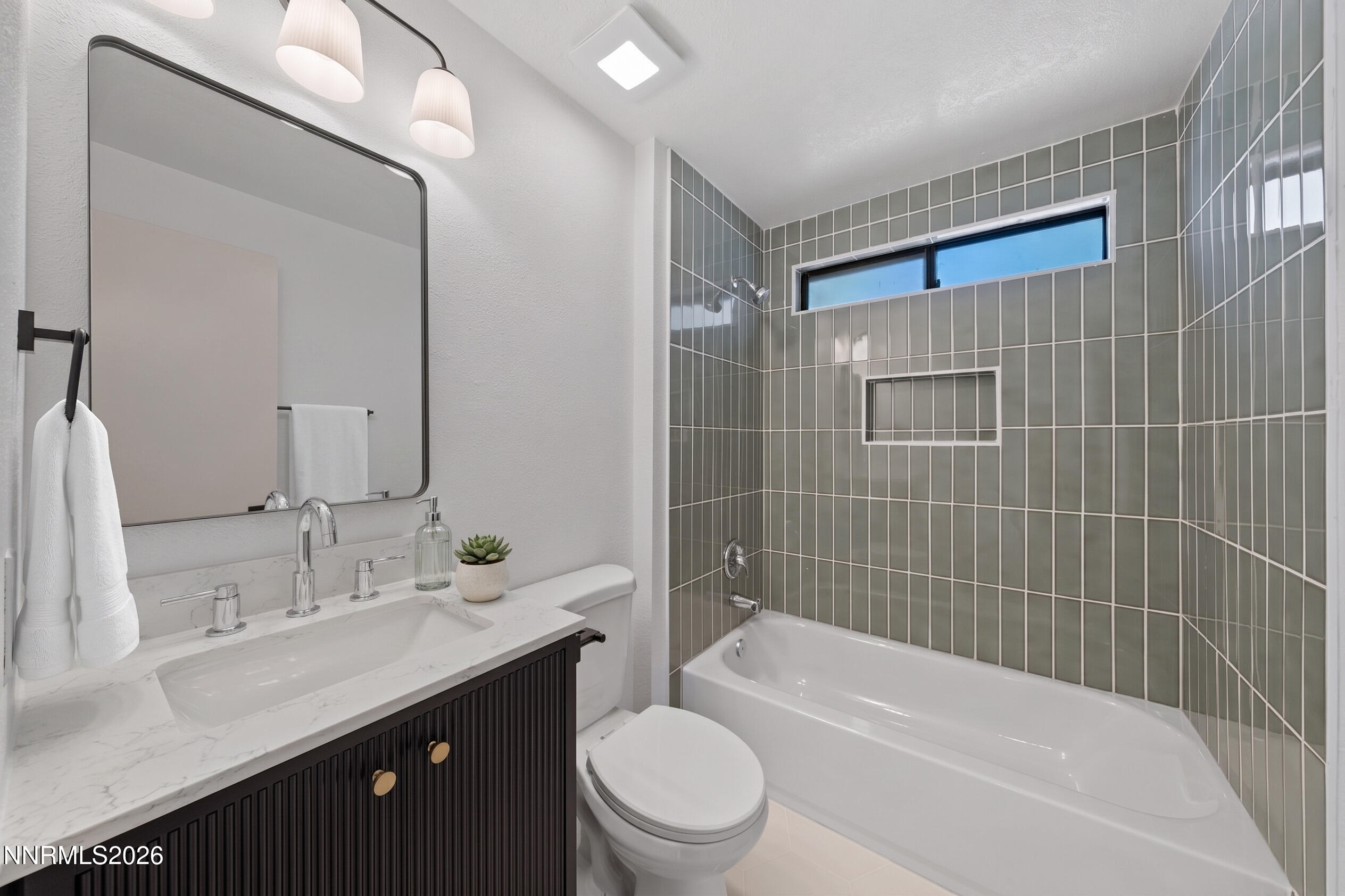 2240 Osceola Court Reno, NV 89506 - Photo 12 of 31 a bathroom with a bathtub shower sink mirror vanity and toilet
