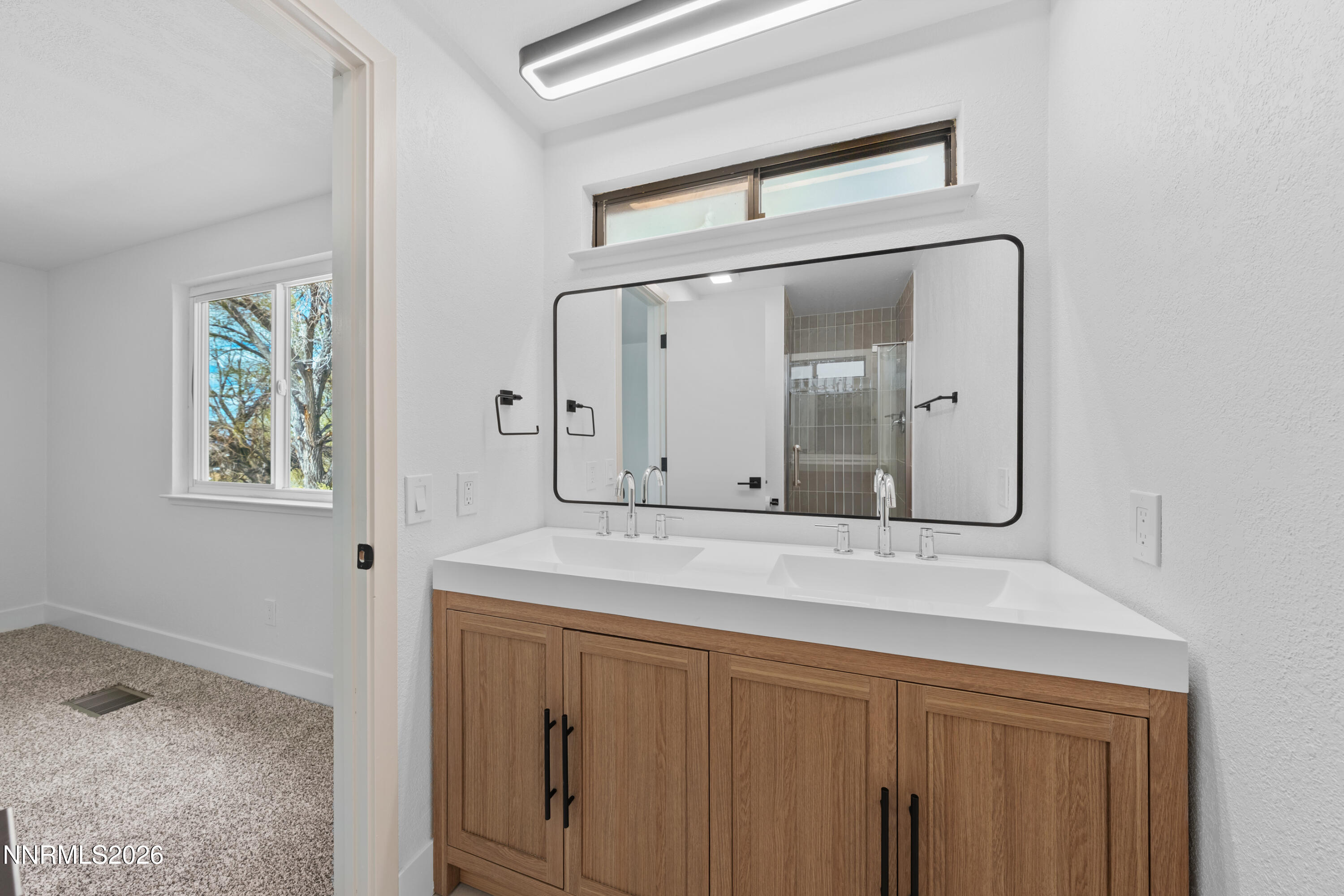 2240 Osceola Court Reno, NV 89506 - Photo 15 of 31 a bathroom with a sink vanity and mirror