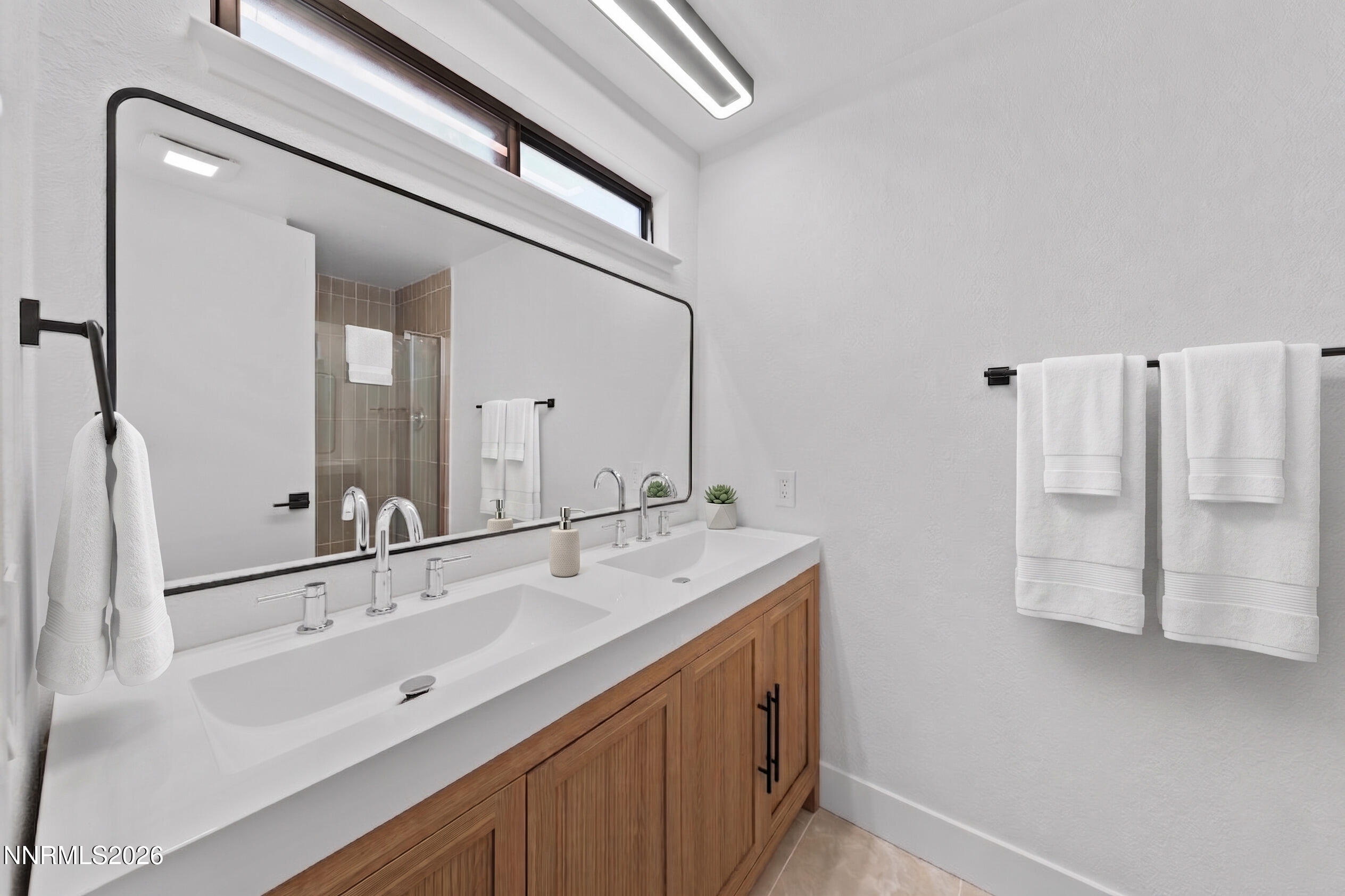 2240 Osceola Court Reno, NV 89506 - Photo 5 of 31 a bathroom with a double vanity sink and mirror