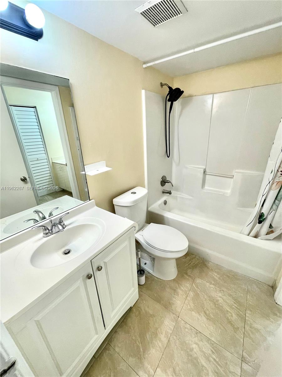 3690 North 56th Avenue, Unit 921 Hollywood, FL 33021 - Photo 22 of 41 a bathroom with a toilet sink and mirror