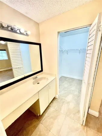 a view of bathroom with mirror