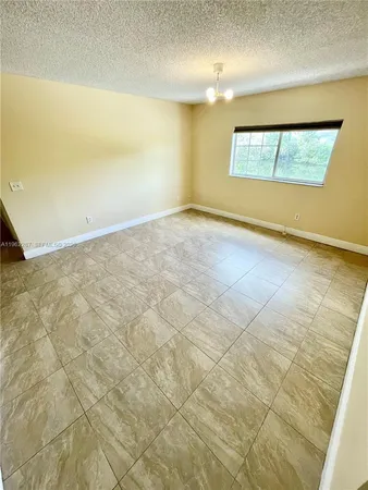 an empty room with a empty space and windows