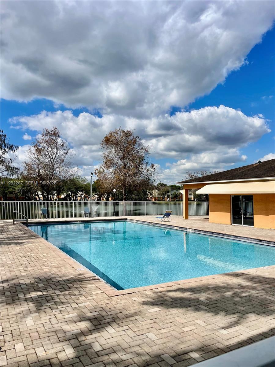 3690 North 56th Avenue, Unit 921 Hollywood, FL 33021 - Photo 40 of 41 a view of a house with swimming pool and mountains in the background