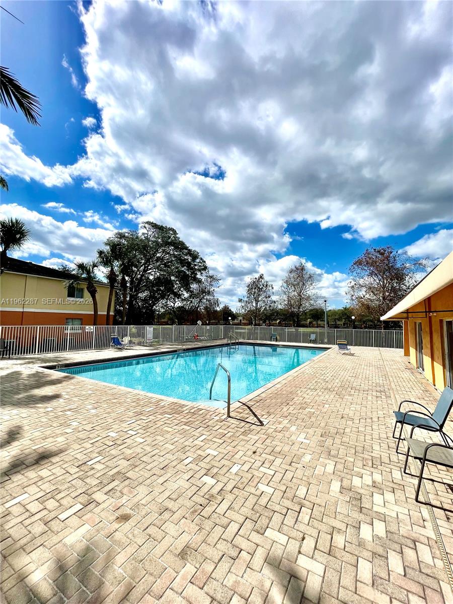 3690 North 56th Avenue, Unit 921 Hollywood, FL 33021 - Photo 41 of 41 a view of a swimming pool with an outdoor space and seating area