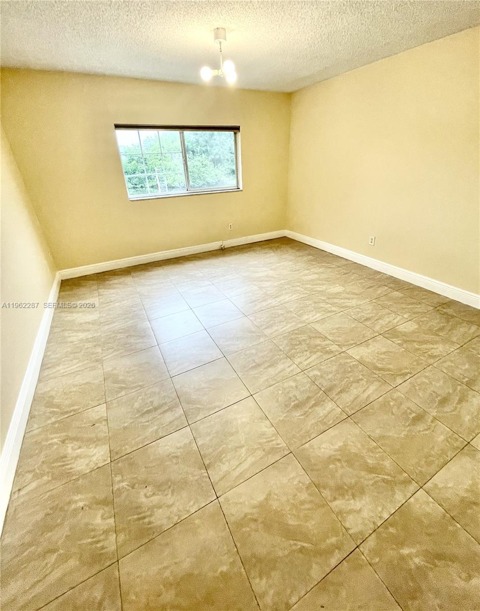 3690 North 56th Avenue, Unit 921 Hollywood, FL 33021 - Photo 5 of 41 a view of an empty room with a window