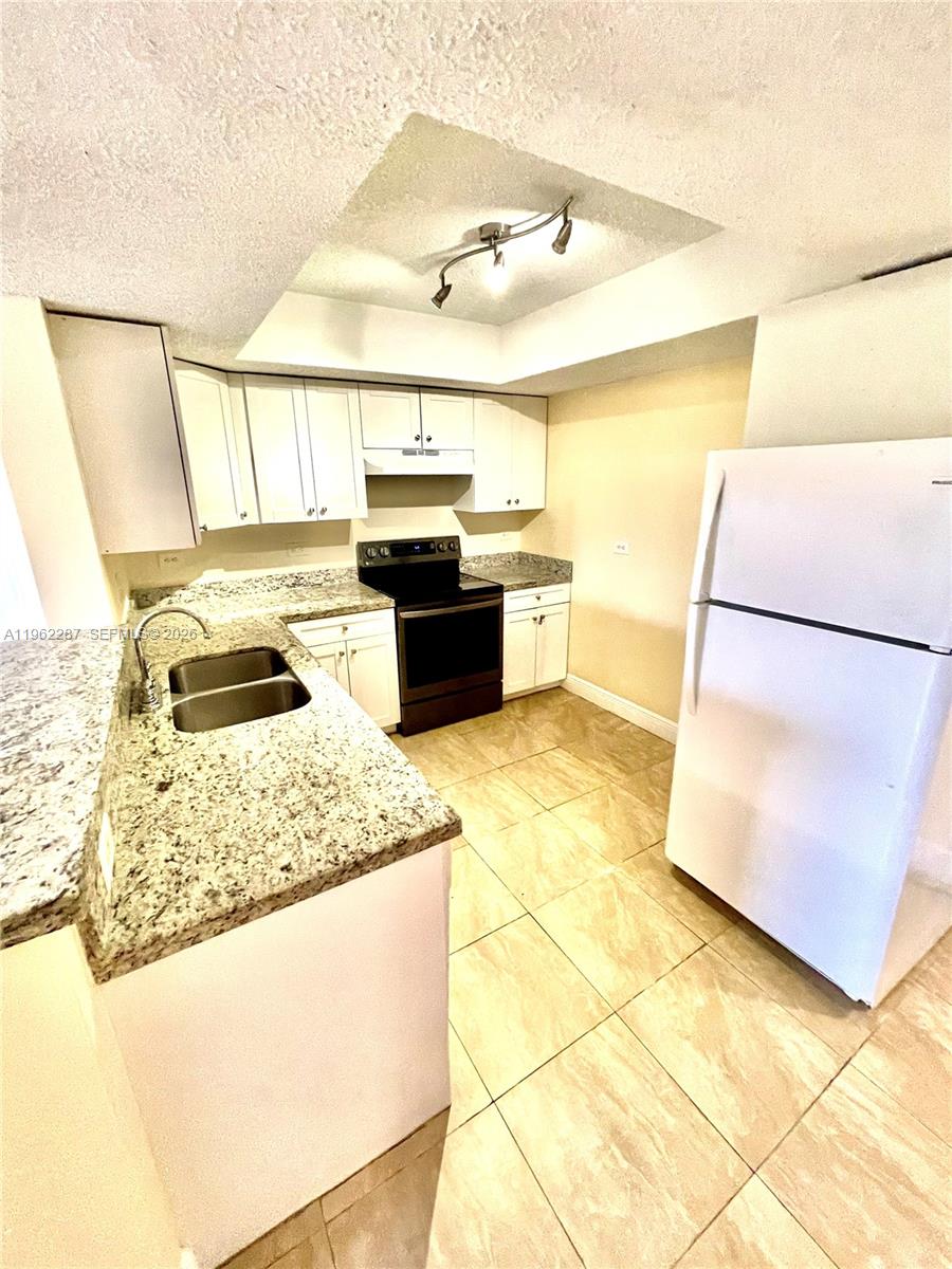 3690 North 56th Avenue, Unit 921 Hollywood, FL 33021 - Photo 10 of 41 a kitchen with stainless steel appliances granite countertop a sink stove and white cabinets