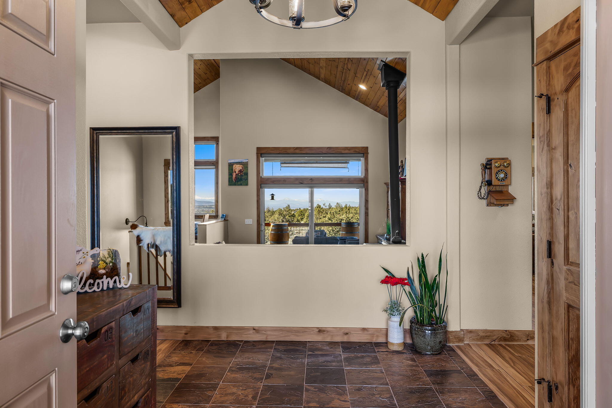6040 Gravett Road Prineville, OR 97754 - Photo 4 of 77 a view of entryway with a flower pot and floor to ceiling window