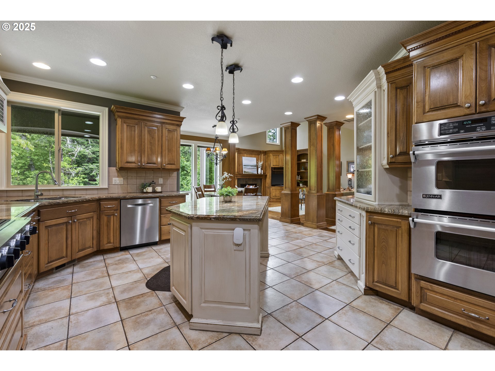 24800 Southwest Big Fir Road West Linn, OR 97068 - Photo 11 of 48 a kitchen with stainless steel appliances kitchen island granite countertop a stove a sink and a microwave
