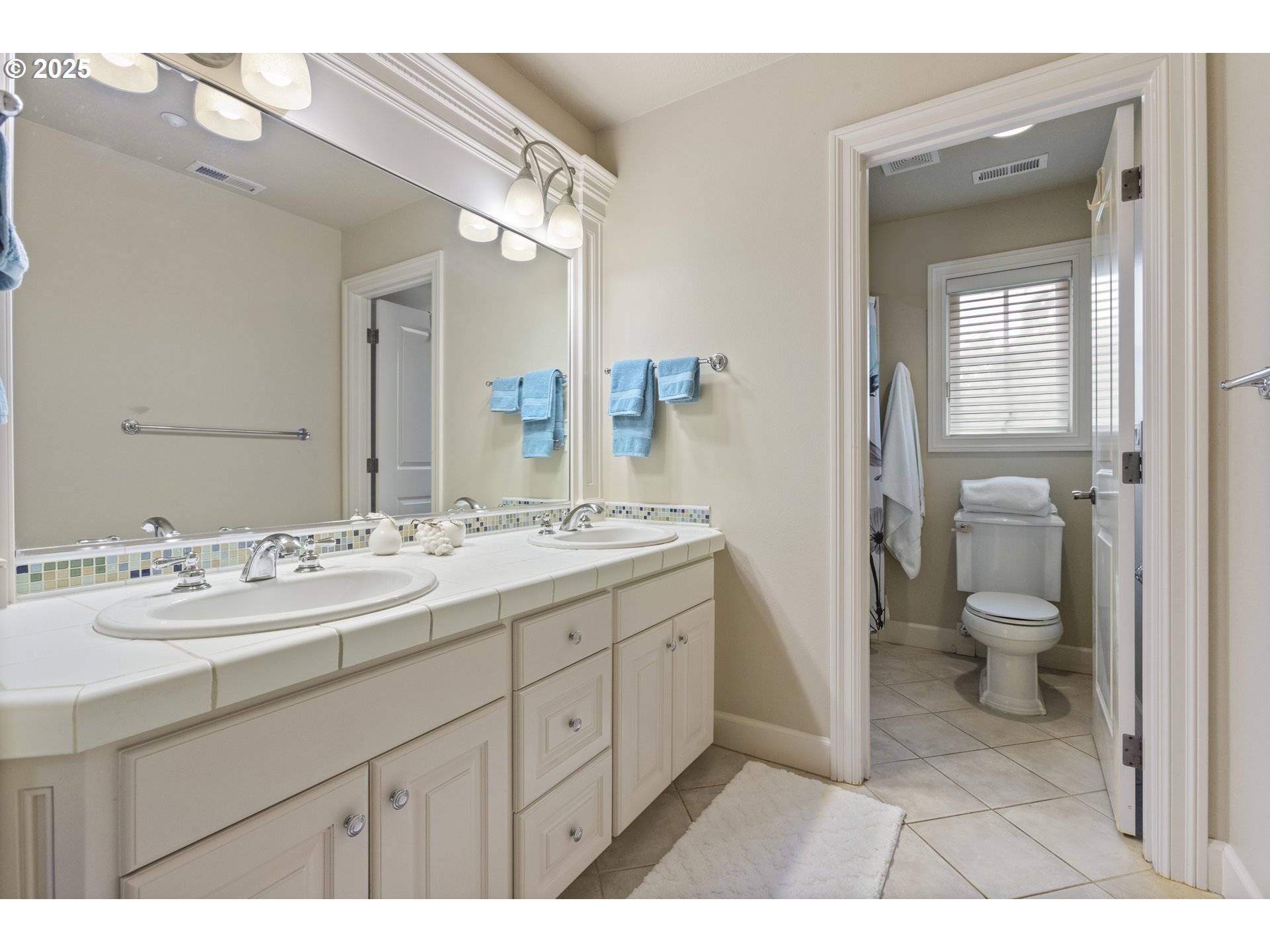 24800 Southwest Big Fir Road West Linn, OR 97068 - Photo 30 of 48 a spacious bathroom with a granite countertop sink toilet mirror and a bathtub