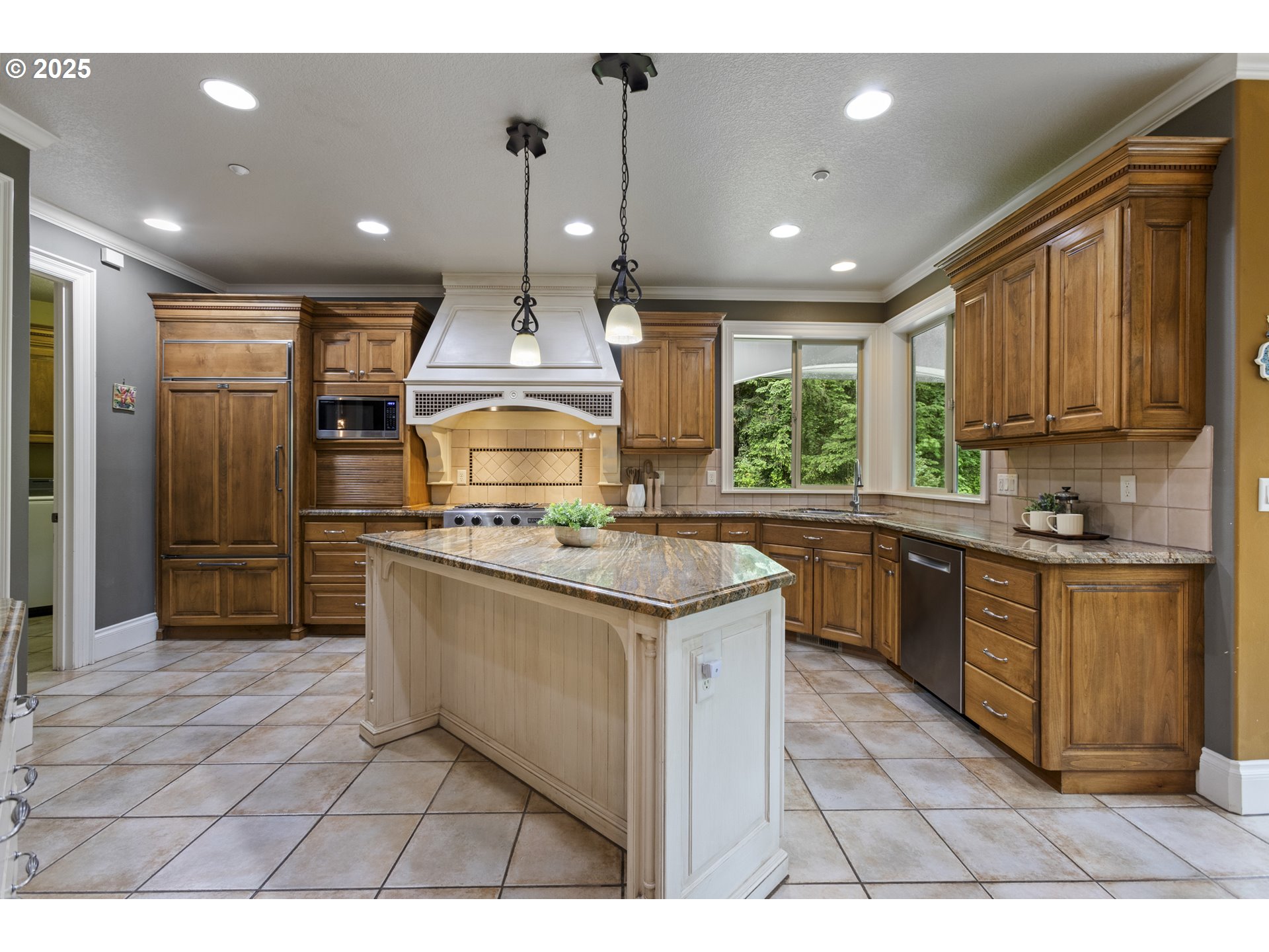 24800 Southwest Big Fir Road West Linn, OR 97068 - Photo 9 of 48 a kitchen with kitchen island granite countertop a sink a counter top space appliances and cabinets