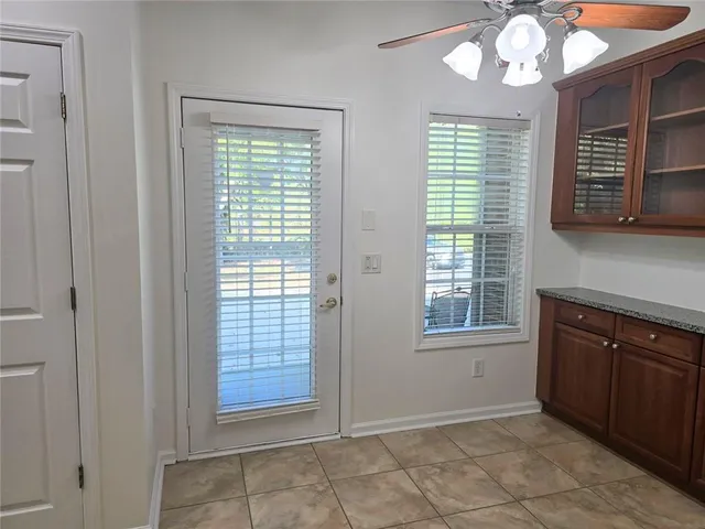 a view of room with a ceiling fan and window