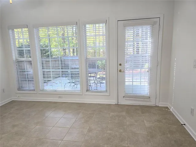 a view of a room with wooden floor and windows