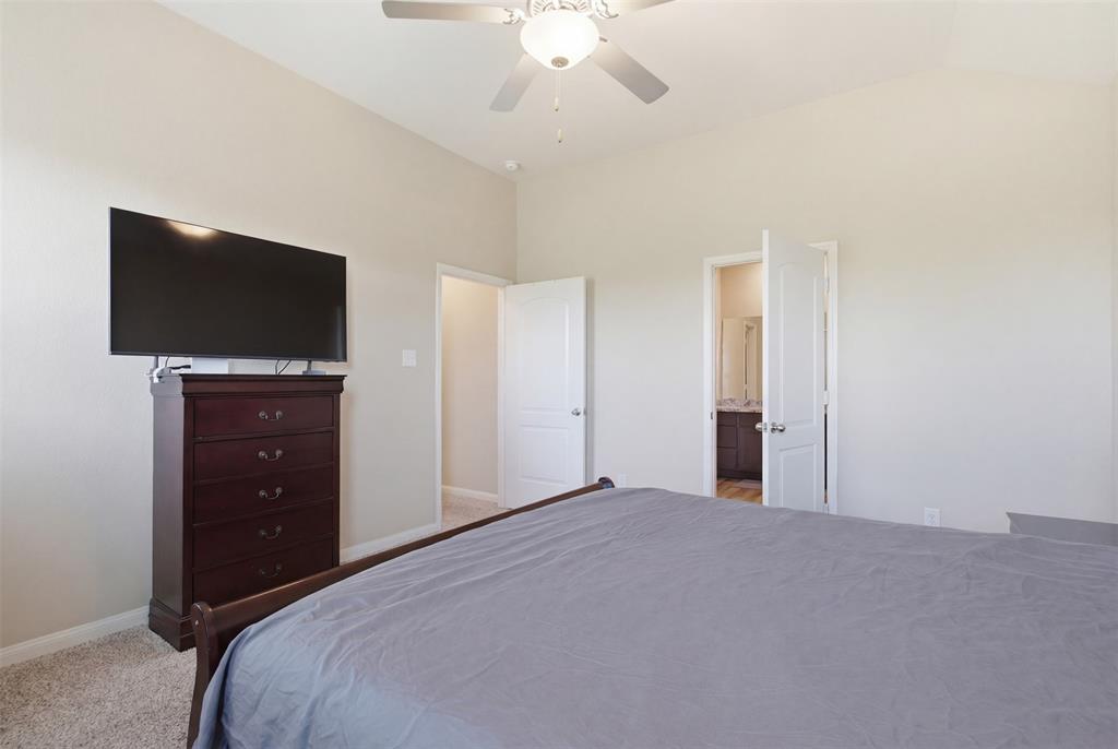 292 Wandering Stream Way Princeton, TX 75407 - Photo 28 of 40 Carpeted bedroom with vaulted ceiling and ceiling fan