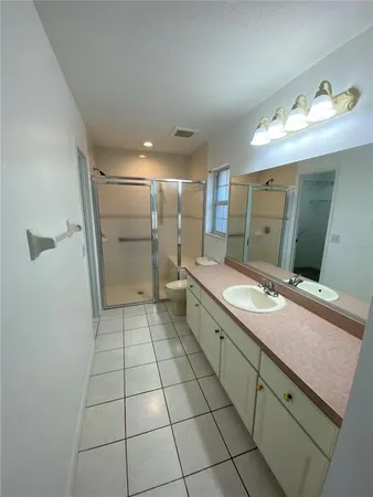 a bathroom with a granite countertop sink mirror and toilet