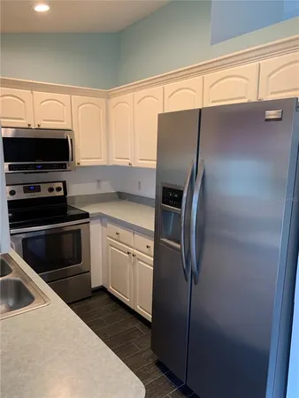 a kitchen with a refrigerator stove and microwave