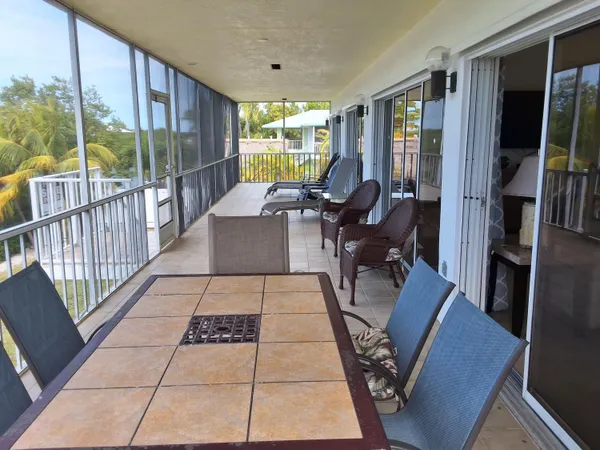 a living room with furniture floor to ceiling window and a table