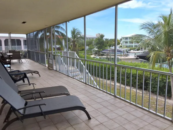 a view of a balcony with couches and wooden floor