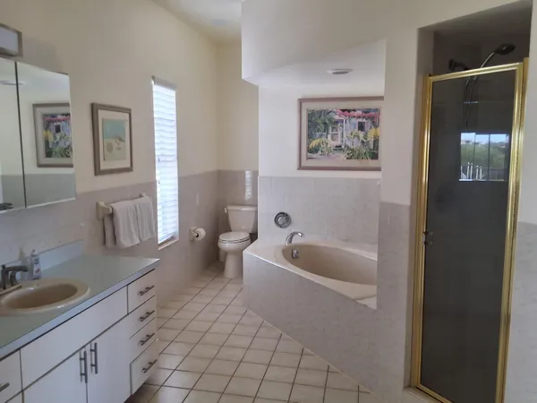 a spacious bathroom with a toilet a sink and bathtub