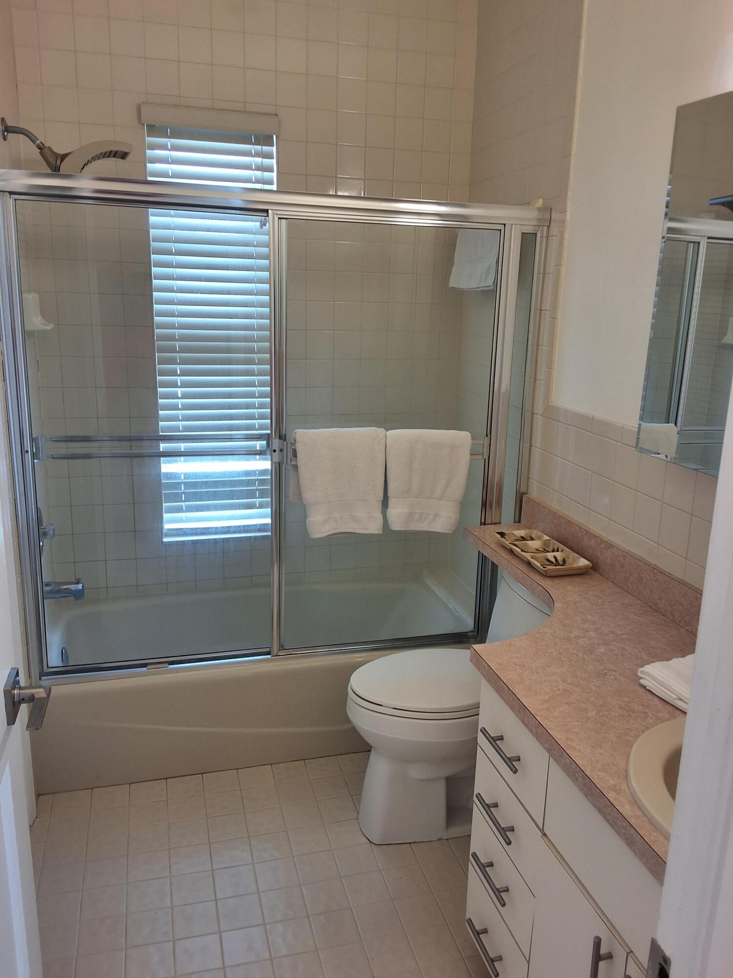 1 Ave F Marathon, FL 33050 - Photo 19 of 36 a bathroom with a granite countertop sink toilet and shower
