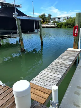 a view of a lake with couches chairs and a table