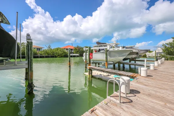 a balcony with view of lake and residential houses with outdoor space