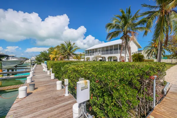 a front view of a house with a yard and fountain