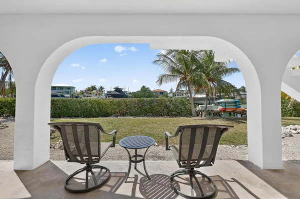 a view of a chairs and table in patio