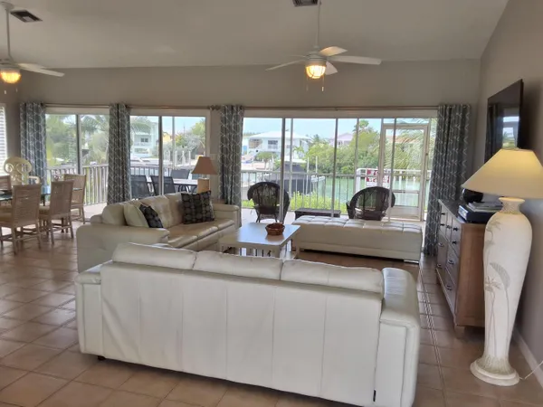 a living room with furniture and large windows