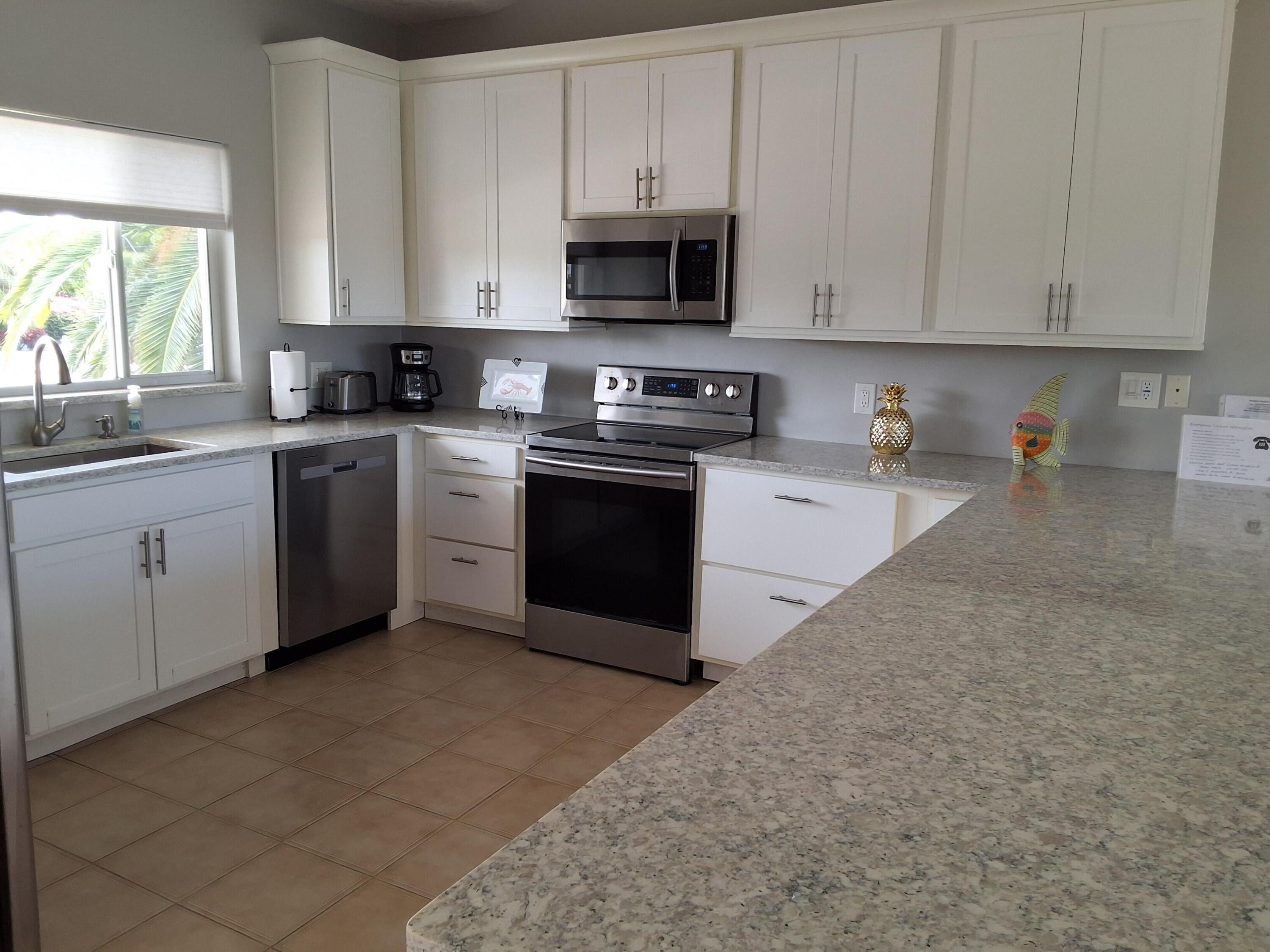 1 Ave F Marathon, FL 33050 - Photo 8 of 36 a kitchen with cabinets appliances and a window