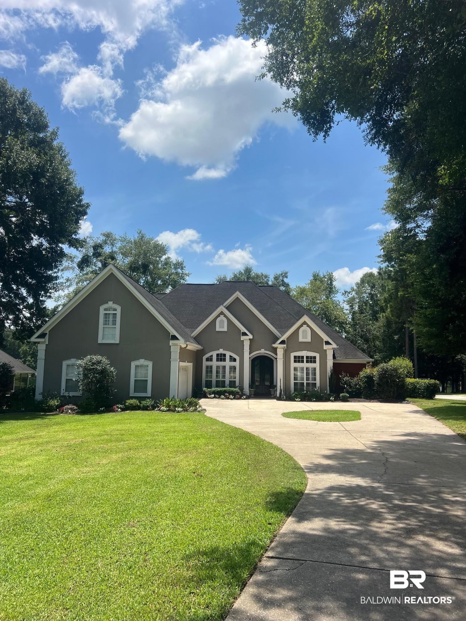 8775 Dawes Lake Road North Mobile, AL 36619 - Photo 6 of 59 View of front of home with concrete driveway, stucco siding, a front yard, and a garage
