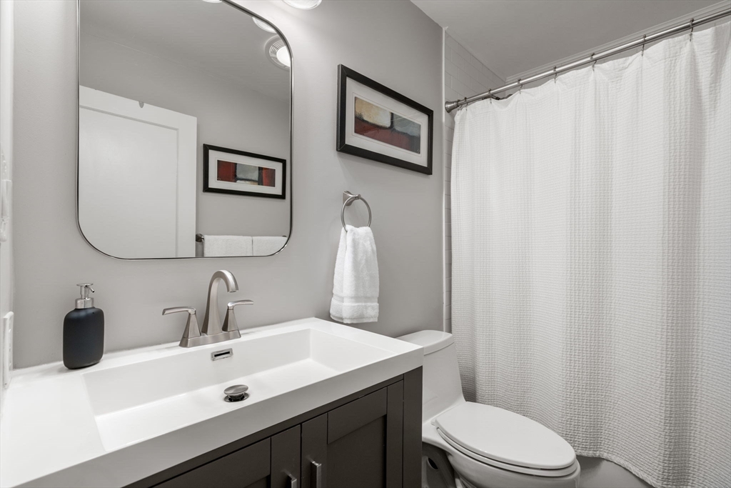 6 Grove Avenue Sharon, MA 02067 - Photo 15 of 27 a bathroom with a sink vanity mirror and toilet