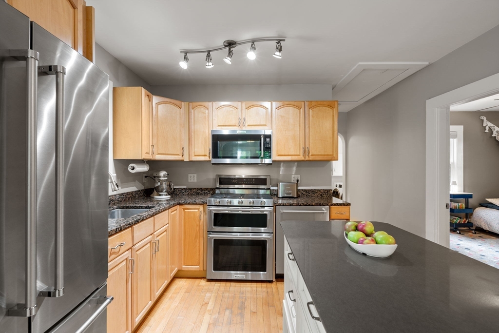 6 Grove Avenue Sharon, MA 02067 - Photo 5 of 27 a kitchen with granite countertop a stove a sink and a refrigerator