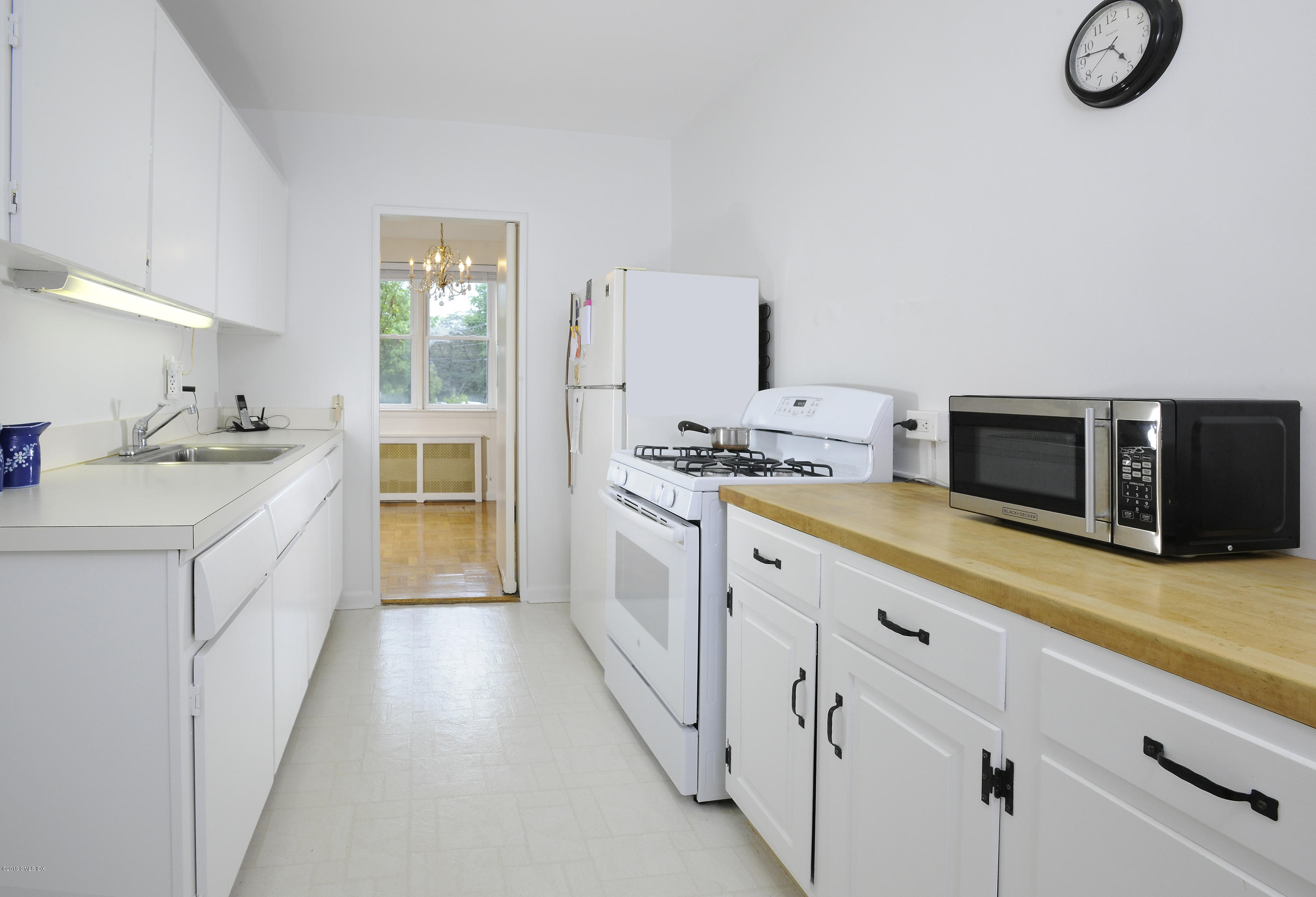 5 Putnam Hill Road, Unit 1D Greenwich, CT 06830 - Photo 1 of 8 a kitchen with granite countertop a sink and a stove top oven