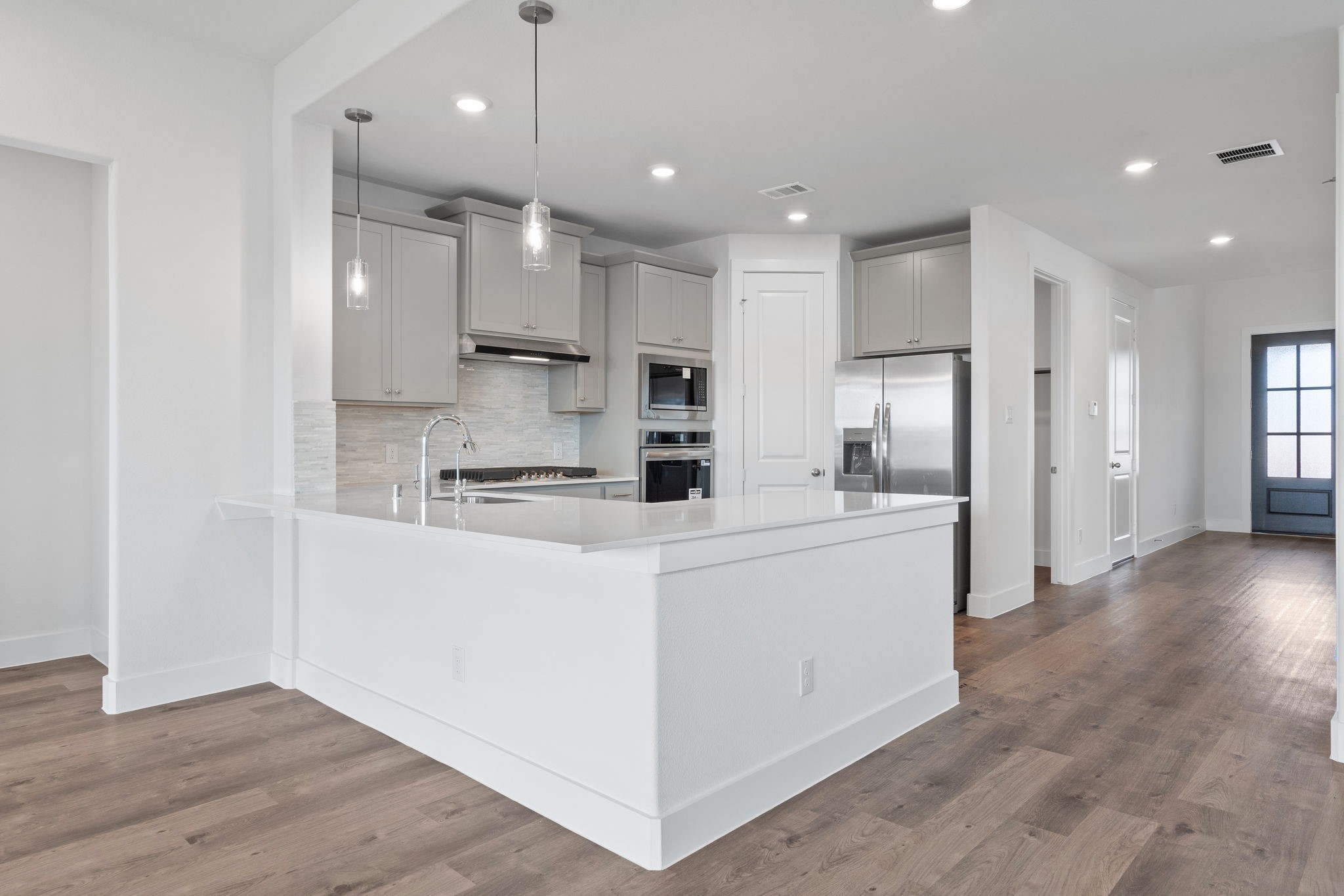 620 Cross Timbers Trace Waller, TX 77484 - Photo 3 of 36 a kitchen with stainless steel appliances kitchen island a refrigerator and a stove top oven