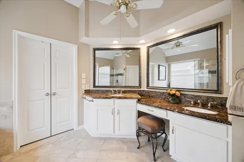 a spacious bathroom with a tub a sink and mirror