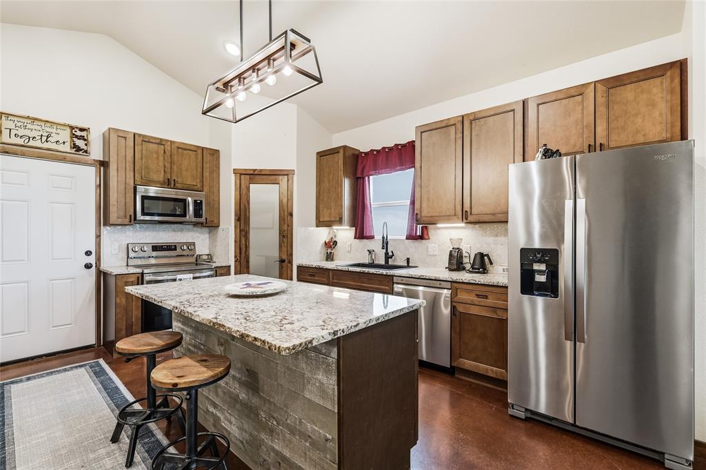 435 County Road 4875 Celeste, TX 75423 - Photo 11 of 35 a kitchen with stainless steel appliances granite countertop a stove refrigerator and microwave